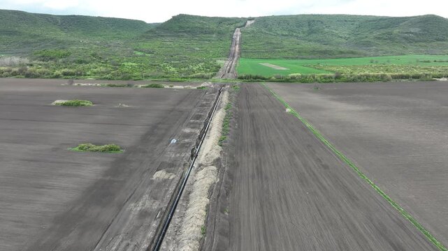 Aerial view of gas and oil pipeline construction. Pipes welded together. Big pipeline is under construction.