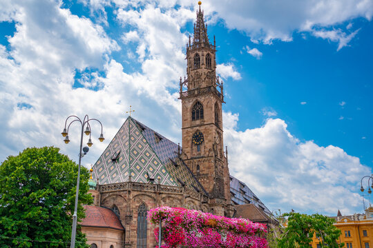 Bolzano Cathedral with colorful tiled roof and Gothic tower in South Tyrol, Italy