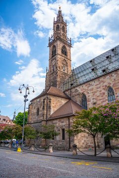 Bolzano Cathedral with Gothic bell tower under a dramatic summer sky in South Tyrol, Italy