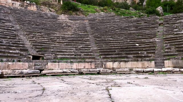 Tilt up from the Theatre of Delphi to the mountains behind the Sanctuary of Delphi, Greece