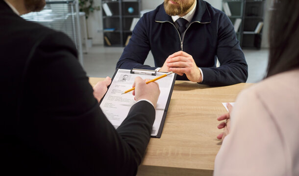 Recruiter conducts interview with candidate resume and CV. Employer listens while HR checks details and evaluates skills to support a fair hiring decision. Clear job hire decision concept.