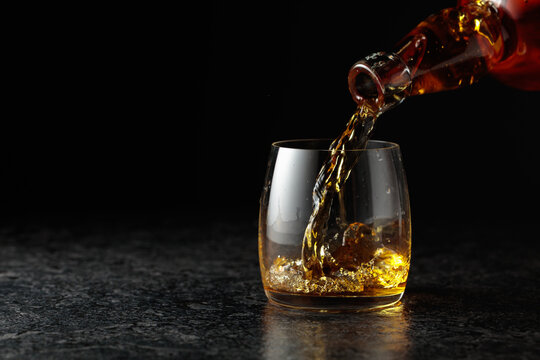 Whiskey is poured into a glass.