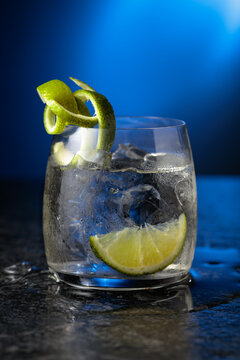 Vodka with lime and ice cubes in a fogged up glass.