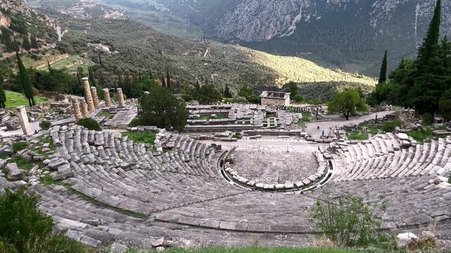Tilt up revealing the Valley of Phocis behind the Theatre at the Sanctuary of Delphi, Greece