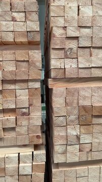 Drewno na paletach do produkcji mebli, okien, konstrukcji, prostokątne drewniane belki ułożone w r&oacute;wne stosy, pionowe ujęcie