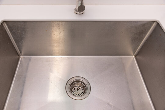 Food scraps in the basket strainer of sink.