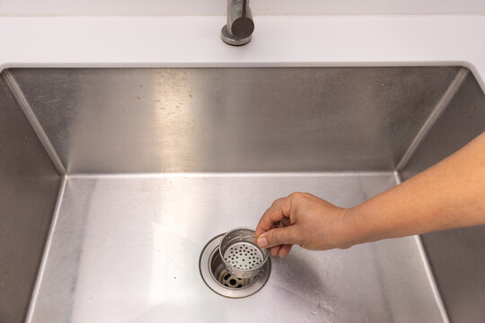 Food scraps in the basket strainer of sink.
