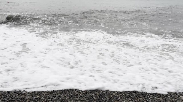 waves roll ashore on a stormy day