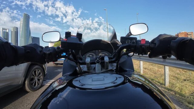 First person point of view motorcycle riding through city traffic