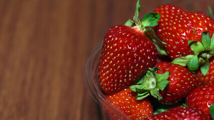 strawberries, juicy, ripe berries. bowl with red strawberries close-up. Fragaria. A plate full of strawberries on the table, macro photo. harvest season, summer vitamins. background, space for text © Oleksandr Filatov