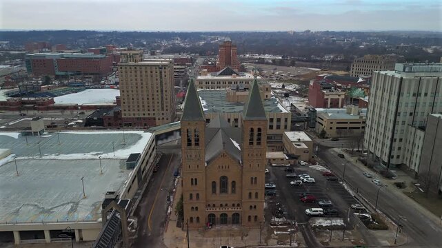 Aerial flythrough between church towers and winter cityscape Akron Ohio