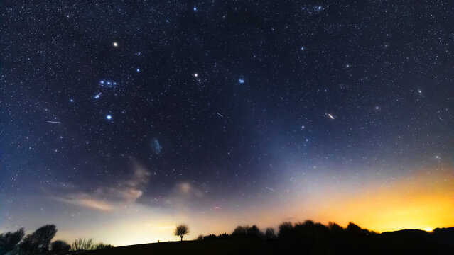 Orion constellation, zodiacal light and Milky Way stars on a dark countryside skies.