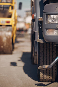 Heavy construction machines and truck outdoors for public street works.