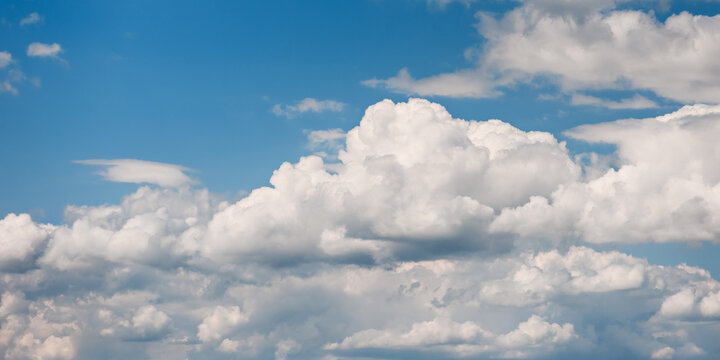 Beautiful blue sky with white cumulus clouds on a sunny day