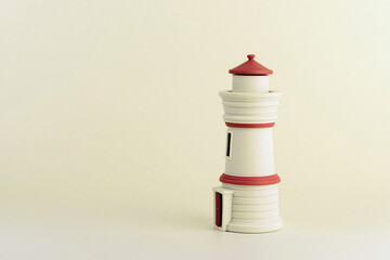 Miniature lighthouse model in white and red navigation and coastal concept © mehmet