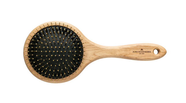 Wooden hair brush with gold pins for grooming routine on transparent background showing quality natural texture and elegant design.