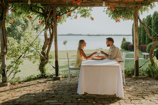 Couple enjoys a romantic dining experience by the serene lakeside