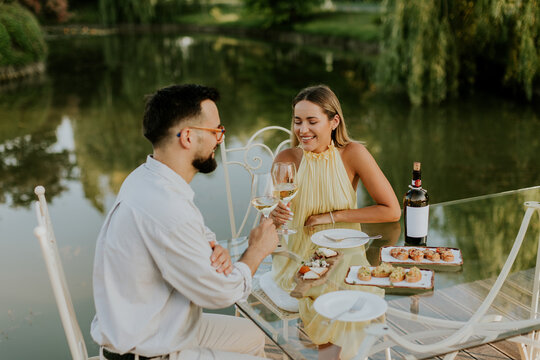 Elegant dinner by the serene lake in a beautiful evening setting