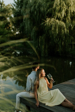 Couple enjoys a serene moment by the calm water during sunset