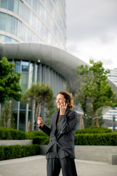 Business professional talking on phone in urban area during cloudy day