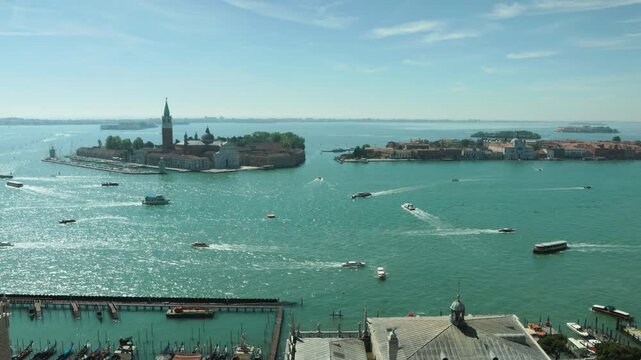Boats navigate the sparkling Venetian lagoon towards San Giorgio Maggiore island on a sunny day. A vibrant panorama inspiring luxury European summer vacations and idyllic travel adventures.