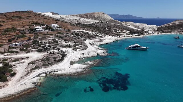 Aerial view of Prassa white sand beach with luxury yacht and catamaran, Kimolos Island, Greece
