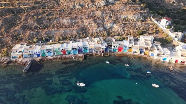 Aerial view of Klima fishing village with colorful syrmata boat houses at sunset, Milos Island, Greece