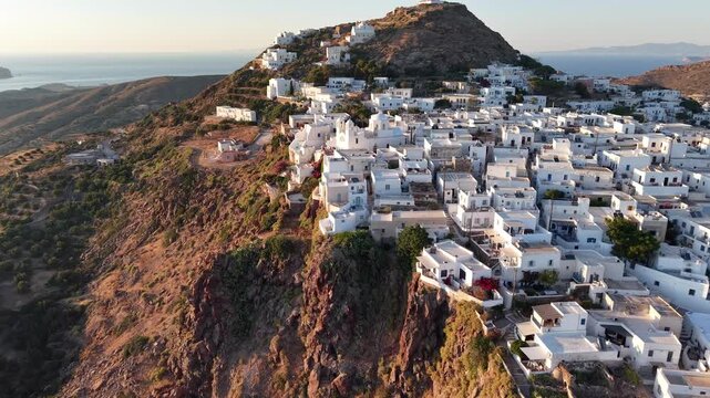 Aerial view of Plaka capital town and Panagia Korfiatissa church at sunset, Milos Island, Greece