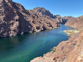 Fototapeta premium Scenic View of a River Surrounded by Rocky Mountains