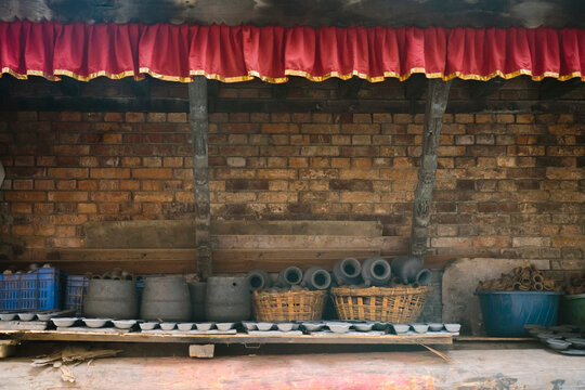Traditional Nepali pottery freshly fired in a kiln in Bhaktapur, Nepal, with handcrafted clay pots arranged to cool, showcasing centuries-old Newari craftsmanship and ceramic-making traditions.