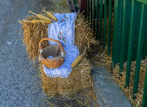 Retro wicker basket on hay inside rural farm interior