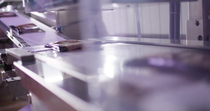 Thermoforming packaging machine sealing meat trays with plastic film