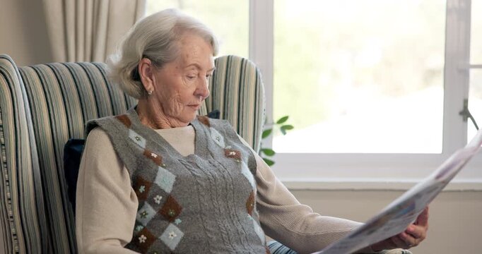 Morning, newspaper and retirement with old woman in living room of home for break or information. Article, check and reading with senior person on chair in apartment for media publication or report