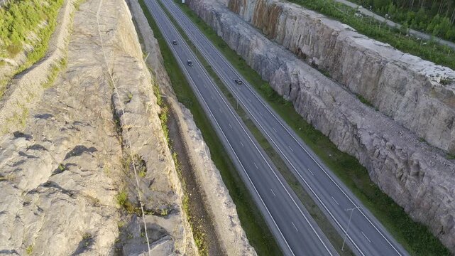 Forward Drone Flight Above Highway Rock Cut at Golden Hour, Finland