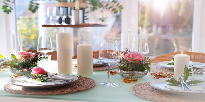 Romantic wedding table decoration. Special event table setting. Arrangement with fresh pink roses and candlelight.