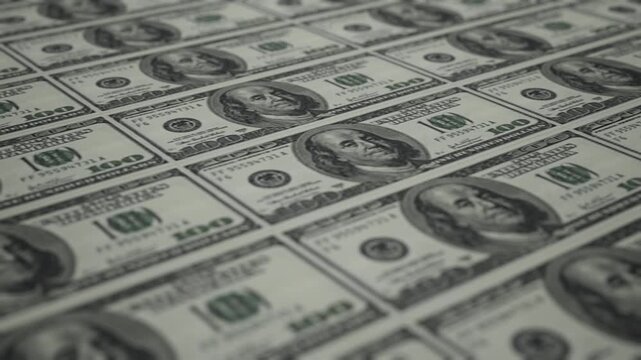 CGI of $100 bills in a tiled pattern. Camera glides over banknotes showing engraving and security details. Ideal for finance and wealth content. Rendered in Unreal Engine.