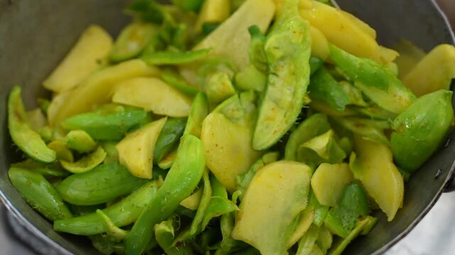 Potatoes and Spiny Gourd Cooking in Traditional Indian Kadhai