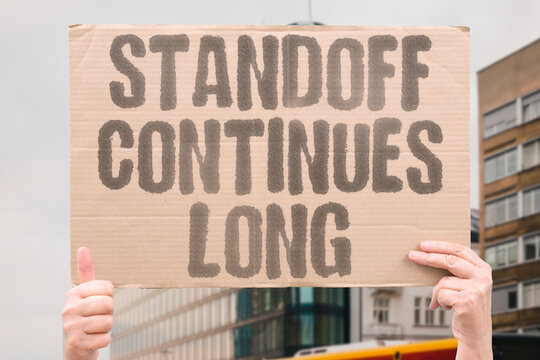 "Standoff Continues Long" The impasse stretches on. STANDOFF.CONTINUES.LONG.IMPASSE.STRETCH.