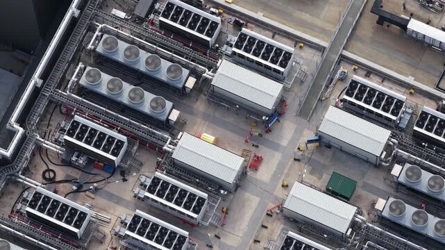 Aerial view of data center cooling system fans spinning on a rooftop