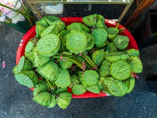 Fresh lotus seed pods displayed for sale at a traditional market © imphilip