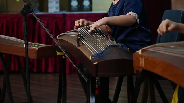 High School Students Playing Gu Zheng Traditional Chinese Zither Musical Instrument in Music Class, Cultural Education and Musicians Rehearsing