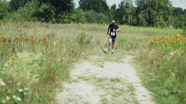 Athlete Running Cross Country. Competition On Field. Marathon Race Outdoors
