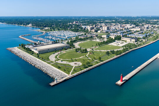 Aerial view of the lighthouse, beach, breakwater, lakefront and downtown along Lake Michigan in Kenosha, Wisconsin in summer.