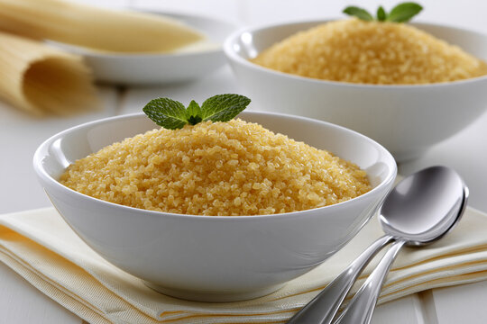 Sugar is placed in a bowl with a mint leaf on top