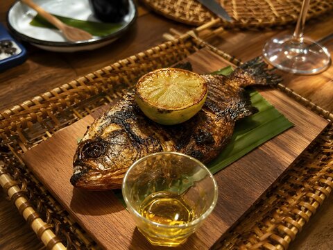 Grilled Piranha Served with Charred Lime and Olive Oil in Amazon Rainforest Restaurant.