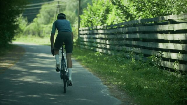 Cyclist Riding Road Bicycle On Asphalt Path In Countryside. Athlete Training Outdoors