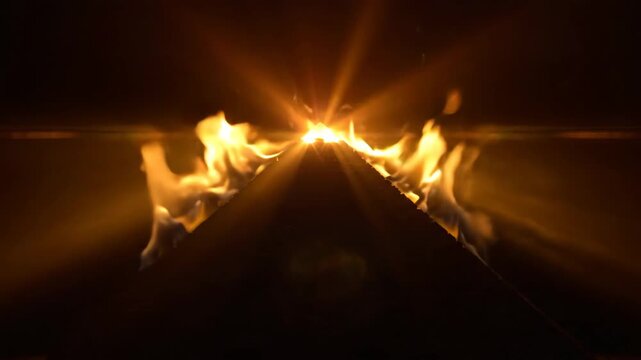 Burning pyramid engulfed in flames on dark background for dramatic cinematic intro