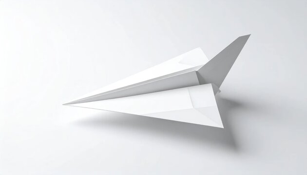 Minimalist white paper airplane against white studio backdrop.