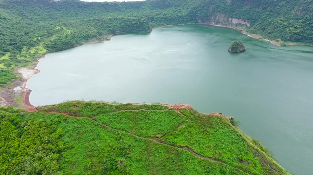 Active Taal volcano and green lake in the crater view from above. Tagaytay Philippines. Green lake- Taal Volcano. Travel vacation concept