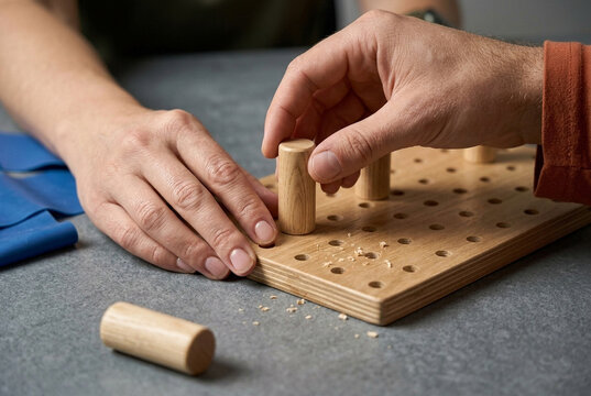 Macro detail of hands engaging in sensory motor exercises with precision wooden tools. Editorial capture of restorative focus, delicate touch, and the quiet luxury of therapeutic progress.
